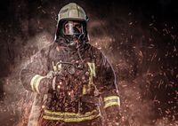 professional-firefighter-dressed-uniform-oxygen-mask-standing-fire-sparks-smoke-dark-background